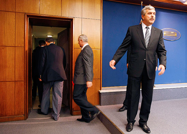 Romania's sacked interior minister Dan Nica (R) gestures to the media after a news conference, as his colleagues from the Social Democrat party leave the room, at Victoria palace in Bucharest October 1,