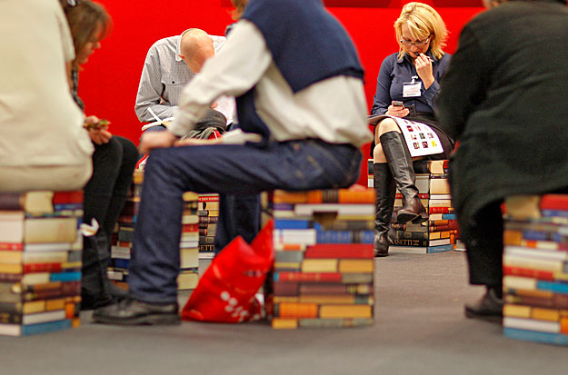 Visitors sit on chairs looking like books at the of Frankfurt book fair October 14, 2009. The world's largest book fair with its focal theme on China's literature will run till October 18 in Frankfurt. REUTERS/Johannes Eisele (GERMANY BUSINESS POLITI