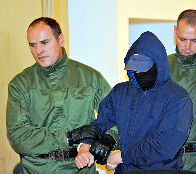 Defendant Alex W., (C) is brought in to a courtroom of the district court in Dresden October 26, 2009. The trial of a man accused of killing a pregnant Egyptian woman in a German courtroom opened on Monday amid tight security, in a case that has ince