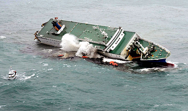 The passenger and cargo ferry Ariake leans to the right while sailing in the Sea of Kumano off Mie Prefecture in central Japan November 13, 2009. All 28 passengers and crew members were rescued according to local media. REUTERS/Kyodo (JAPAN DISASTER)