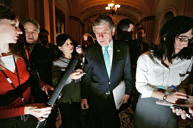 U.S. Senator Ben Nelson (D-NE) (C) is trailed by reporters as he talks about a compromise for his vote on healthcare legislation at the U.S. Capitol in Washington December 19, 2009.  U.S. Senate Democrats said they reached agreement on an abortion co