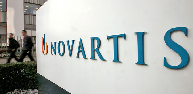 People walk past the logo of Swiss drugmaker Novartis at the company's plant in Basel January 28, 2009. Novartis's fourth-quarter net profit rose 62 percent to $1.5 billion, driven by sales of blood pressure and cancer drugs, but missed forecasts as 