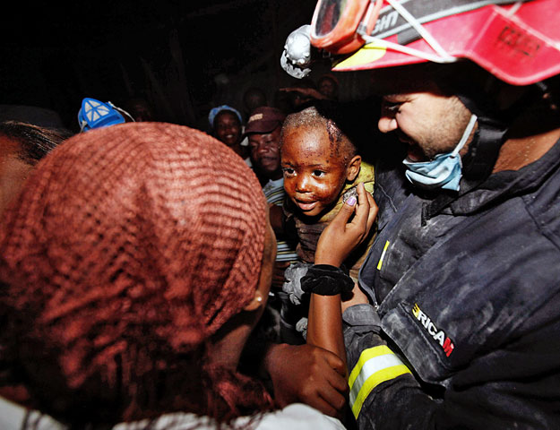 A kétéves Redjeson Hausten mosolyog édesanyjára, miután spanyol és belga mentők kimentették a kisfiút otthonának romjai alól