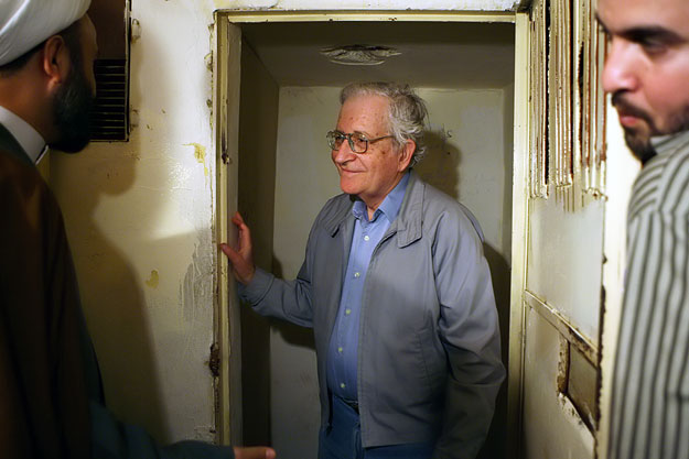 Hizbollah official Sheikh Nabil Kawook (L) speaks with academic and linguist Noam Chomsky (C) during Chomsky's visit to a former Israeli prison in al-Kiam village in south Lebanon near the border with Israel, May 13, 2006.  REUTERS/Jamal Saidi