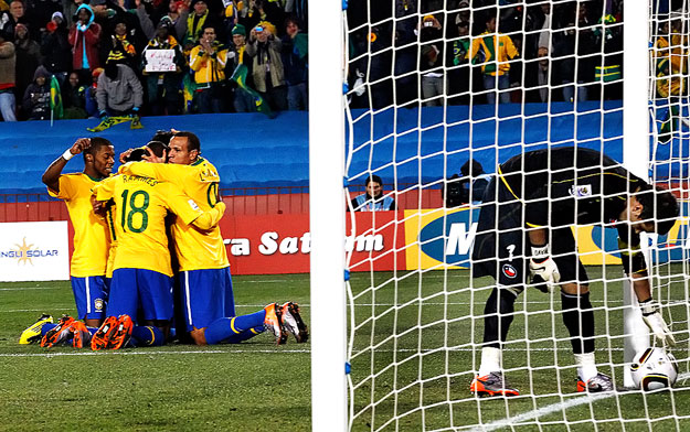 Brazil's Robinho (obscured L) celebrates with team mates after scoring against Chile during a 2010 World Cup second round soccer match at Ellis Park stadium in Johannesburg June 28, 2010.  