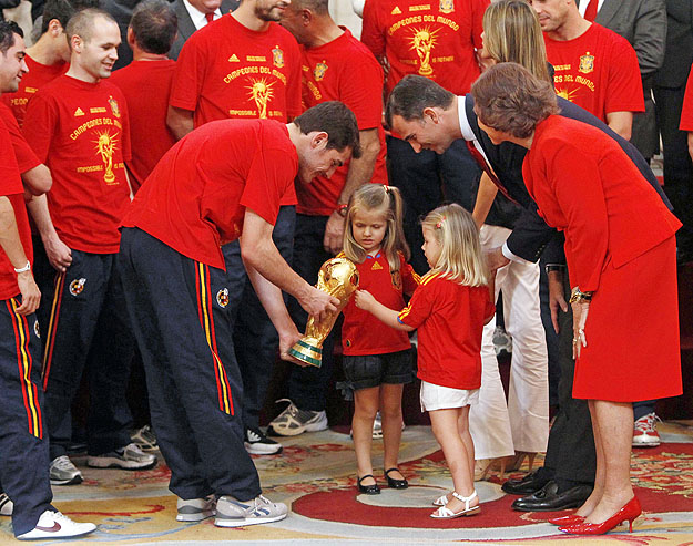A spanyol királyi család legifjabb tagjai  ismerkednek a Spanyolország által elnyert 2010-es világbajnoki trófeával a kapus, Iker Casillas segtségével