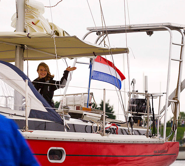 Laura Dekker of the Netherlands waves to well wishers as she sails her boat Guppy out of the harbour of Den Osse August 4, 2010. Dekker, 14, sets sail for Portugal on Wednesday, after winning a year-long battle with child welfare authorities worried 