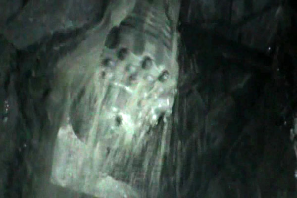 A frame grab shows the drill bit of the T-130 drilling machine after digging a 12-inch guide hole to a garage next to the refuge where 33 miners are trapped deep underground inside a copper and gold mine near Copiapo September 17, 2010. The T-130 wil