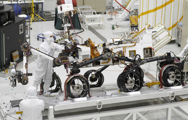 A technician removes a component from NASA's Mars Science Laboratory rover 'Curiosity', where it is undergoing pre-flight tests in the 'clean room', at the spacecraft assembly facility at the Jet Propulsion Laboratory in Pasadena, California Septembe