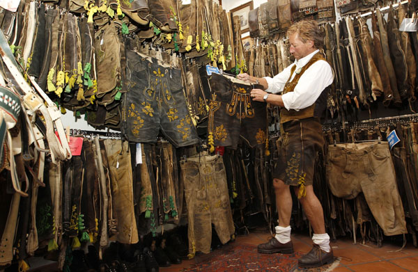Herbert Lipah, owner of the traditional clothes shop 'Lederhosenwahnsinn' (Lederhosen crazy) arranges one of his 2,500 pairs of second-hand and new leather trousers in Munich September 16, 2010. Lipah, who has collected leather trousers over the past