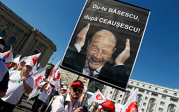 A trade union member holds a portrait of Romania's President Traian Basescu during a protest in downtown Bucharest September 22, 2010. More than 5,000 unionists protested against austerity measures pushed by Romania's government to meet its IMF loan 