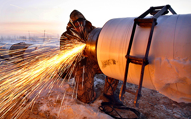 A Gazprom worker welds a part of a pipeline, some 10 km (6 miles) from the town of Novy Urengoy, December 17, 2007. Russia and Germany launched work on the enormous Yuzhno Russkoye gas field in northwest Siberia on Tuesday, which will be jointly deve