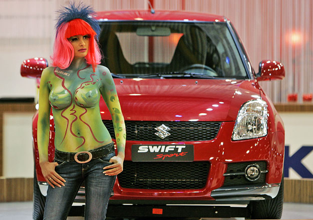 A model poses next to a Suzuki Swift Sport before the opening of the International Motor Show in Brussels January 12, 2007.  REUTERS/Thierry Roge   (BELGIUM)

TEMPLATE OUT