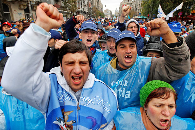Members of trade unions march on the streets against the government's austerity measures that coincided with a no-confidence vote in parliament in Bucharest, October 27, 2010. Romania's centrist government looks likely to survive a no-confidence vote