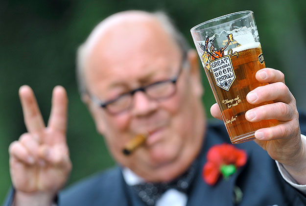 An impersonator of wartime British prime minister Winston Churchill poses with a pint of real ale while promoting the start of the Great British Beer Festival at Earl's Court in west London August 3, 2010.  The Campaign for Real Ale (CAMRA) which hos