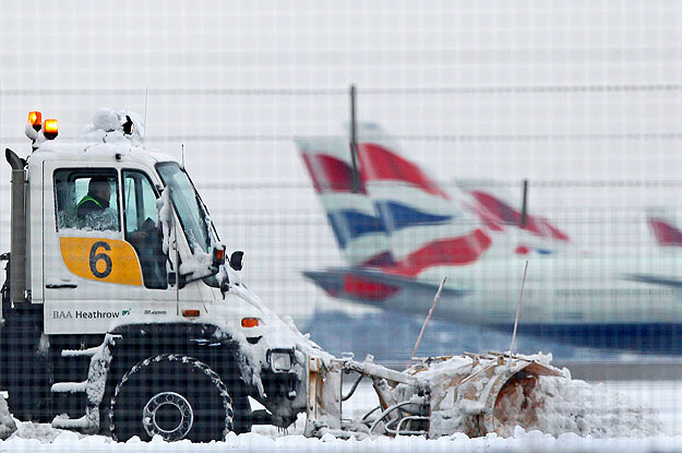 A snow plough is driven by a worker at Heathrow Airport in west London December 19, 2010.  Britons Sunday faced little respite from the Arctic conditions that have disrupted travel and shopping plans on the last weekend before Christmas, normally one