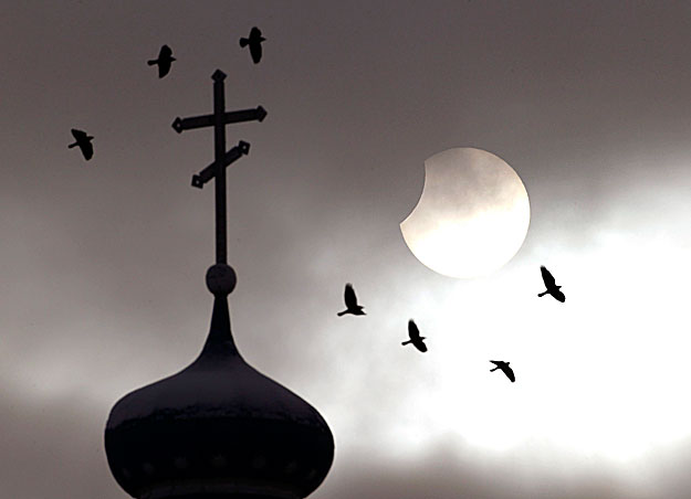 A részleges napfogyatkozás egy ortodox templom felett Minszk környékén