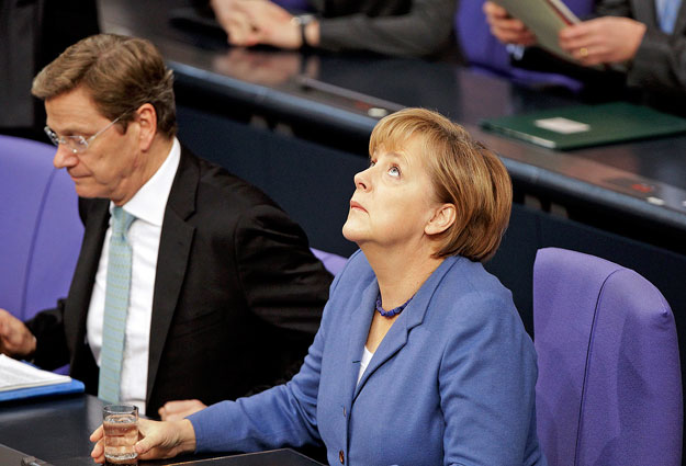 German Chancellor Angela Merkel and Foreign Minister Guido Westerwelle attend a session of the German lower house of parliament Bundestag in Berlin, November 24, 2010.     REUTERS/Tobias Schwarz     (GERMANY - Tags: POLITICS)