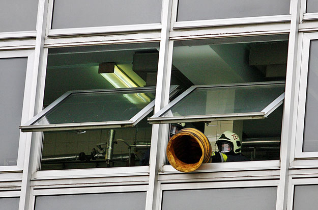 Egy tűzoltó ventillátorral szellőztet a Zala Megyei Kórház ablakában