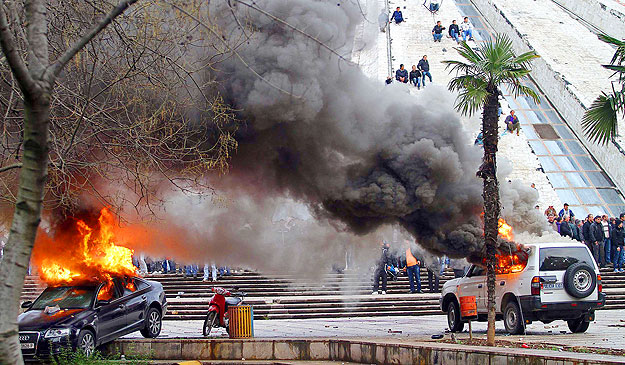 Two cars are set on fire during riots on Friday between supporters of Albania's opposition Socialist Party and police in front of the government building in Tirana January 21, 2011. The opposition had called the rally to demand fresh elections and th