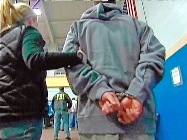 Federal Bureau of Investigation (FBI) agents arrest more than 100 organized crime suspects in New York, in this still image taken from WNBC-TV video footage from early January 20, 2011. 