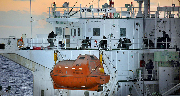 South Korean naval special forces take up positions during an operation to rescue crew members on the Samho Jewelry vessel in the Arabian Sea January 21, 2011. South Korea's navy has rescued all crew members aboard a South Korean chemical ship hijack