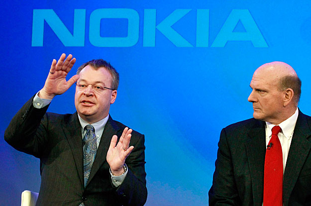 Nokia chief executive Stephen Elop (L) speaks, watched by Microsoft chief executive Steve Ballmer at a Nokia event in London February 11, 2011. Nokia and Microsoft teamed up to build an iPhone killer on Friday in a desperate attempt to take on Google
